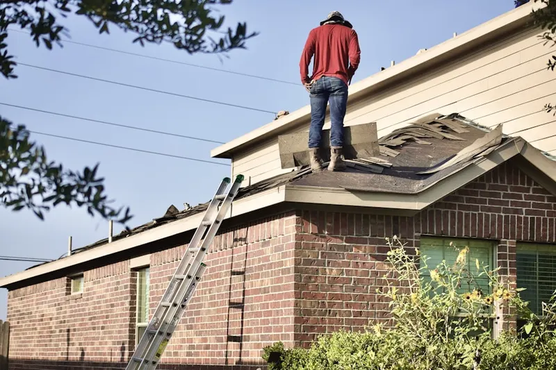Professional roofer working on a residential roof in Rambleton Acres